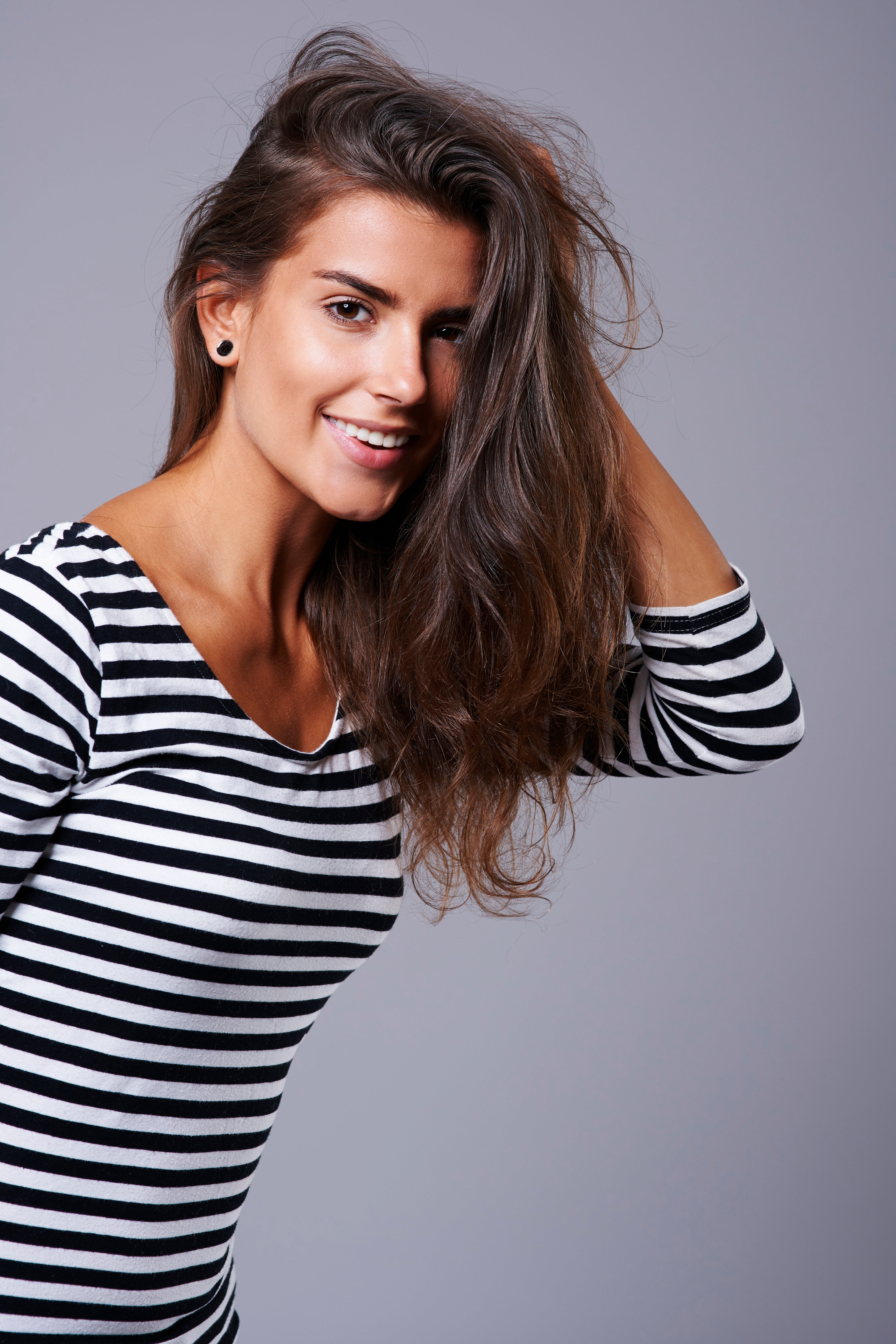 Young woman with healthy long brown hair — the MD® Nutri Hair multi-pathway protocol that protects against GLP-1 weight-loss telogen effluvium