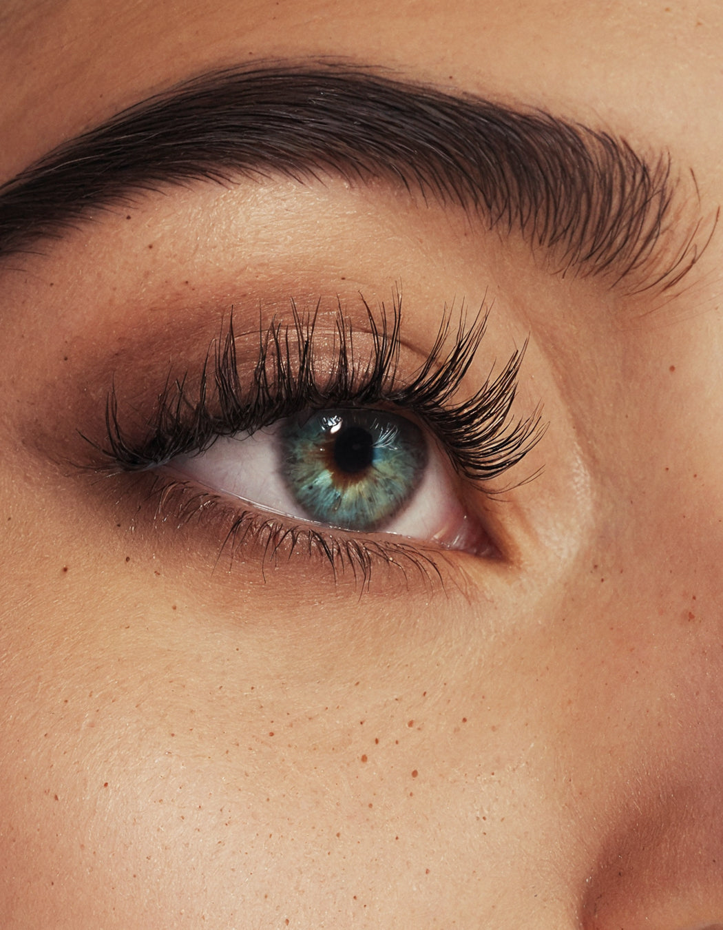 Elegant photo featuring the MD Lash Factor eyelash care tube. The model’s lashes look long and lush, enhanced by the precision bristles and high-quality serum from MD-Lash