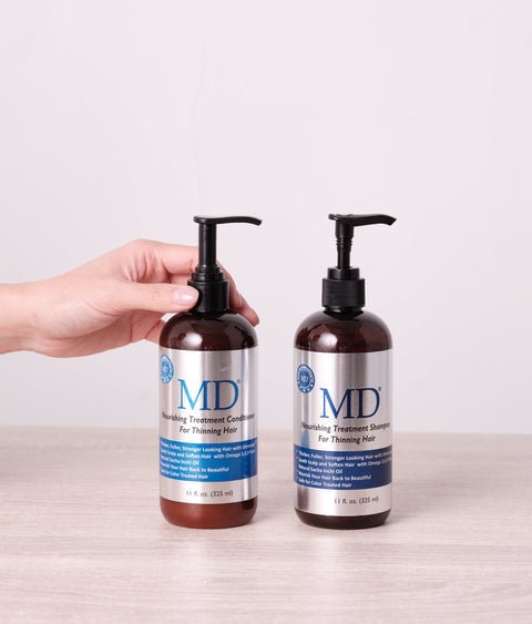 Hand holding MD Nourishing Treatment Shampoo and Conditioner from MD Hair, for thinning hair and scalp health